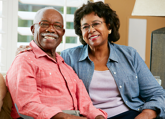 Image of senior couple in their home smiling