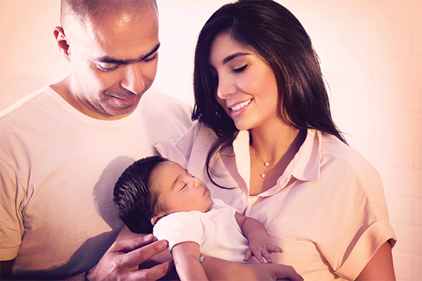 image of couple with newborn discussing midwifery