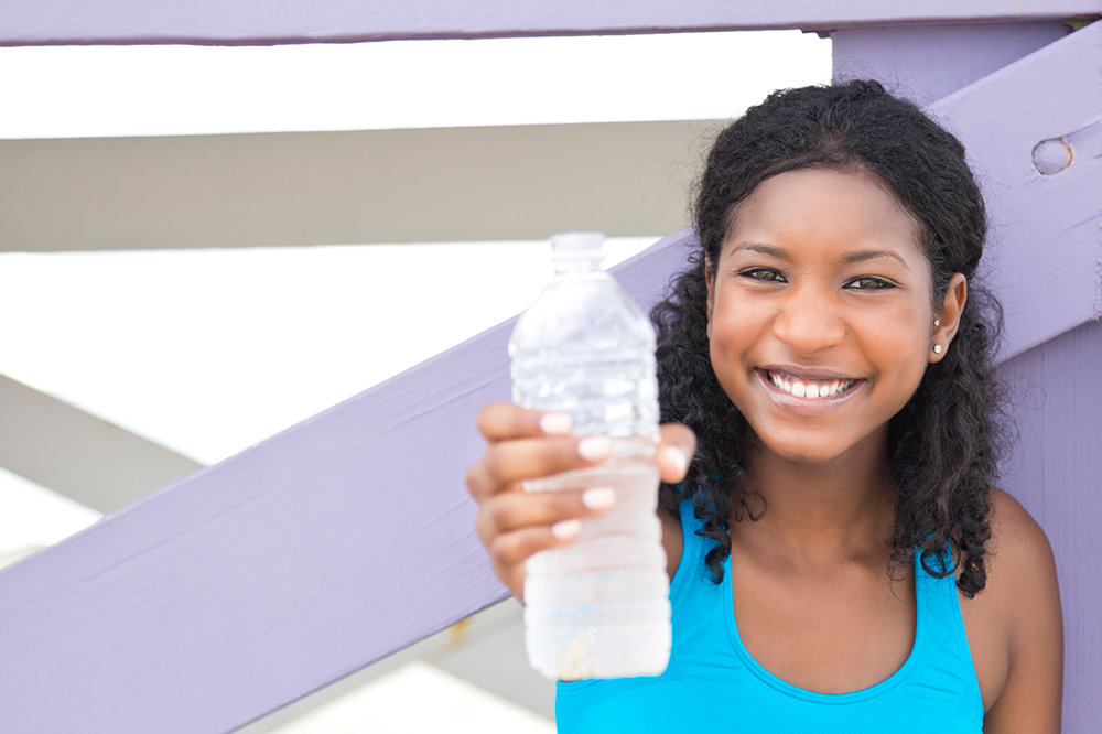 Image of woman staying hydrated by drinking water