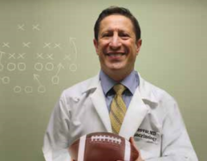 Image of Dr. Brovar holding football
