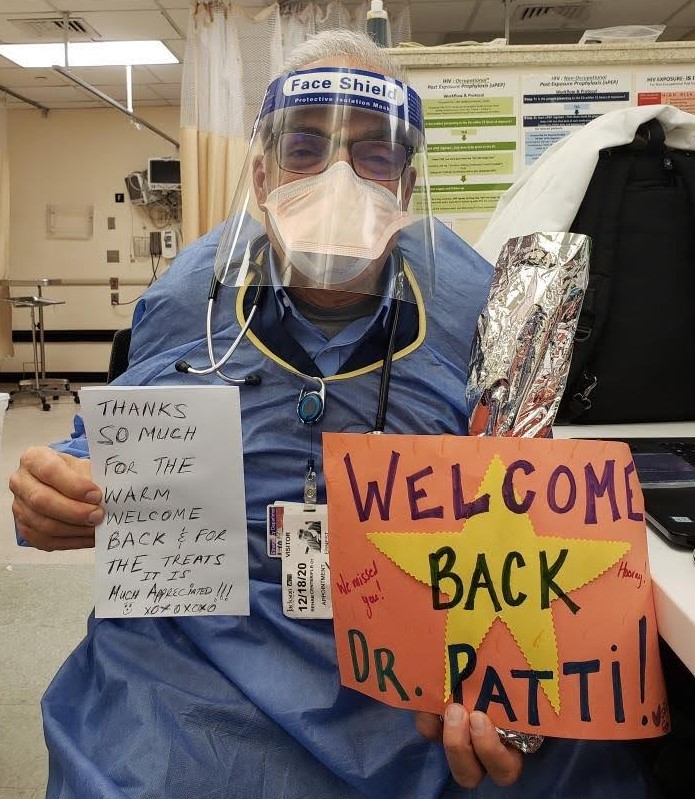 Picture of Dr. Ernest Patti, SBH Emergency Department holding welcome back signs