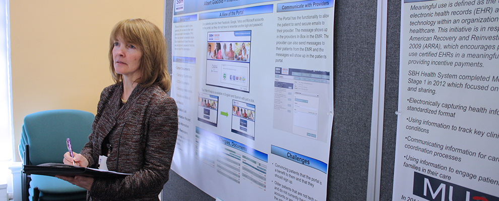 image of Ruth Cassidy reviewing research posters