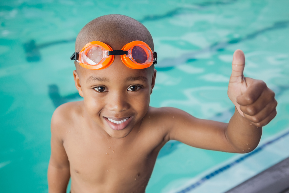 Image of little boy at pool avoiding summertime injuries
