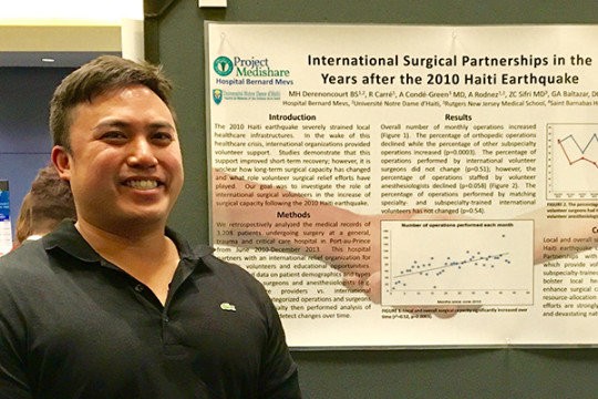image of Gerard A. Baltazar DO FACOS in front of the scientific poster