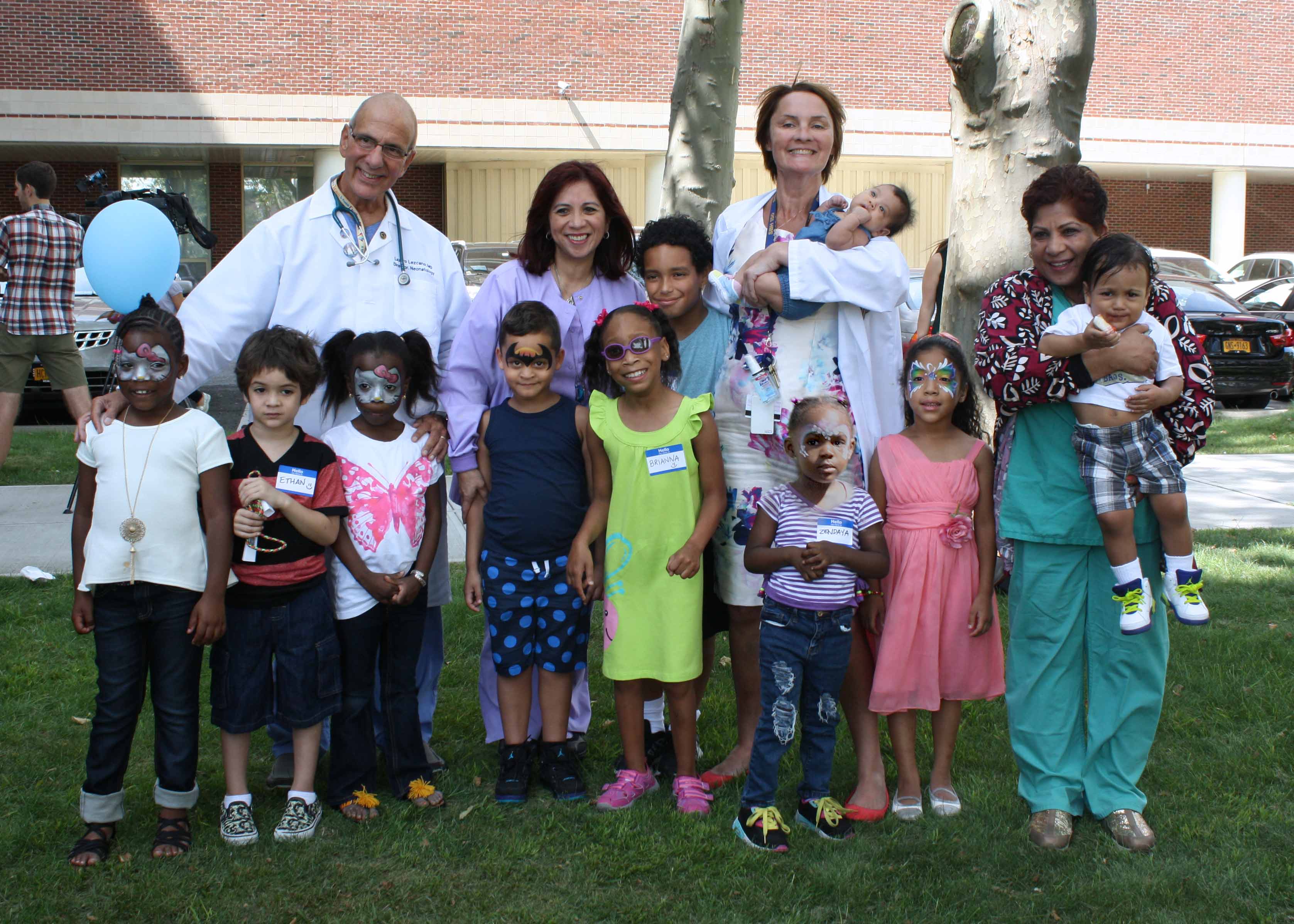 Image of Dr. Lezcano and his staff with ten children from the SBH NICU