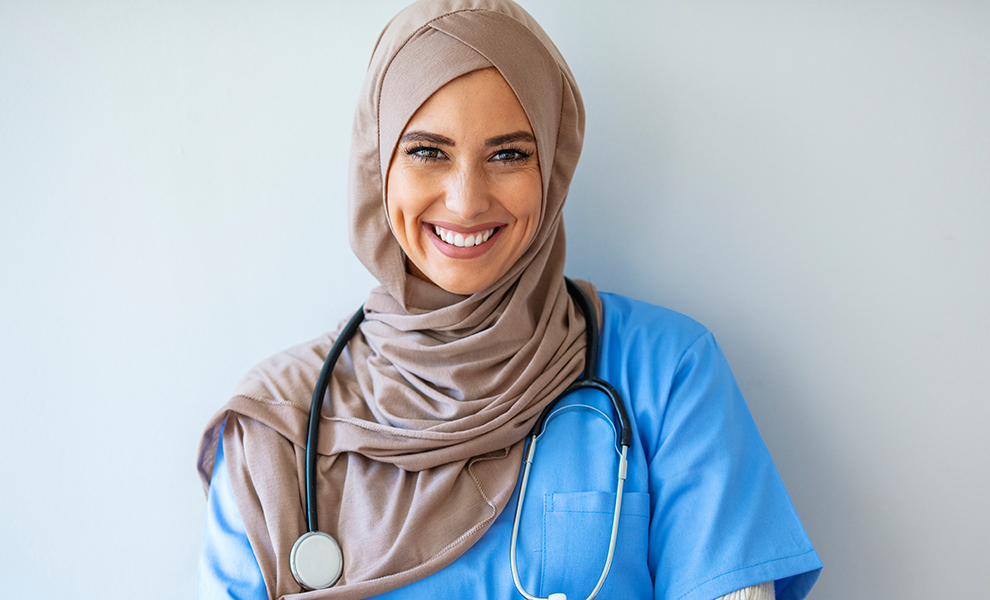 Picture of Confident Muslim female doctor standing inside hospital. Portrait of Muslim Doctor with stethoscope. Confident Muslim medical student pose at hospital. Confident Muslim doctor